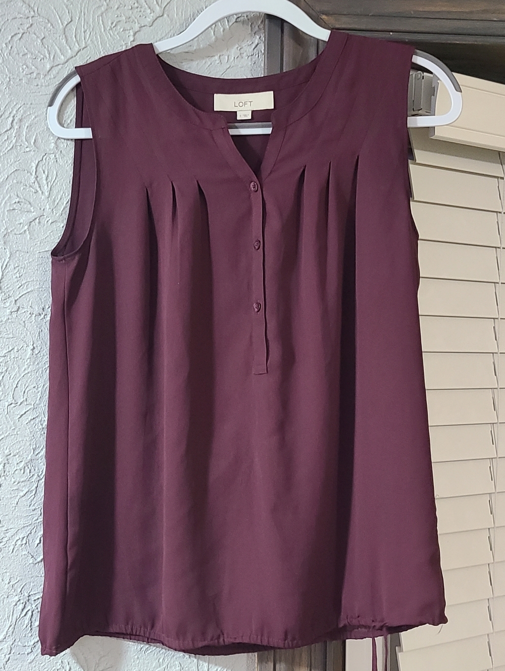 maroon/burgundy sleeveless blouse from LOFT featuring a button-down V-neck